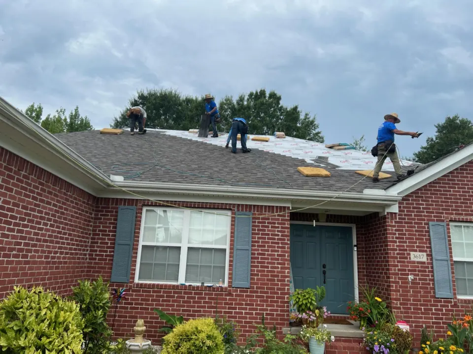 Crew working on a brick ranch home