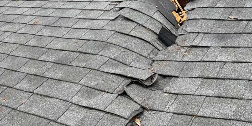 Storm-damaged shingles ready for repair