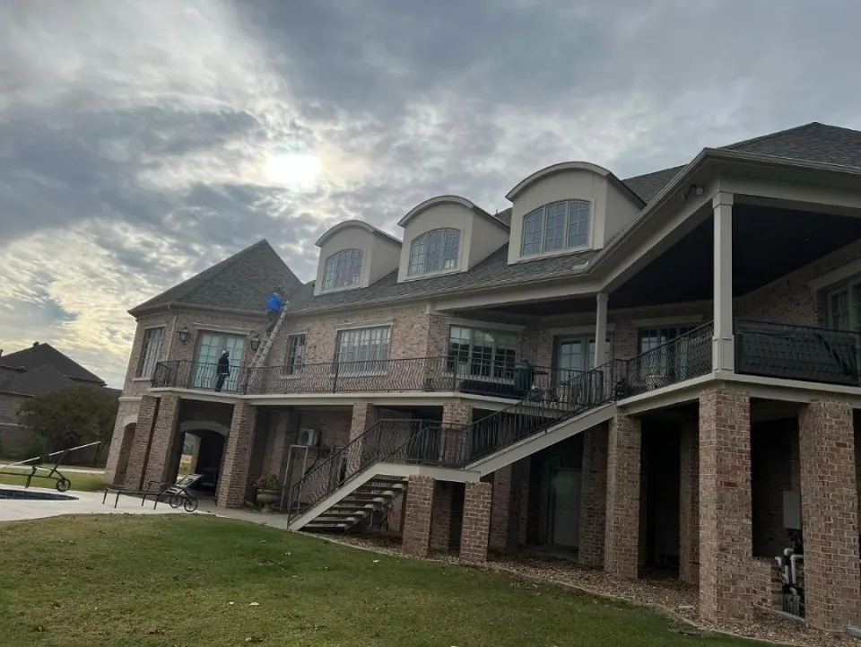 Large brick home with a replaced roof