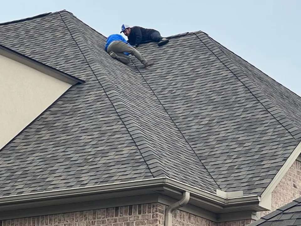 Roofer working on a steep roof section