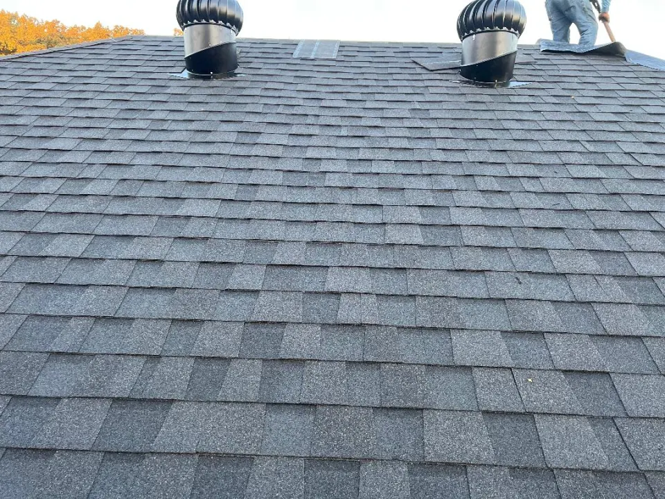 Asphalt shingle roof with ventilation turbines after repairs